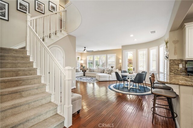 living room featuring dark hardwood / wood-style floors and ceiling fan