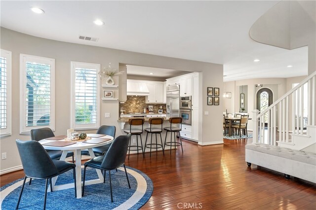 dining area featuring dark wood-type flooring