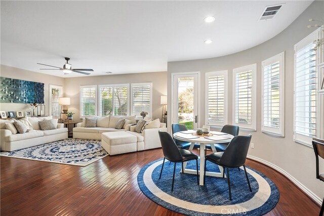 dining space with dark wood-type flooring and ceiling fan