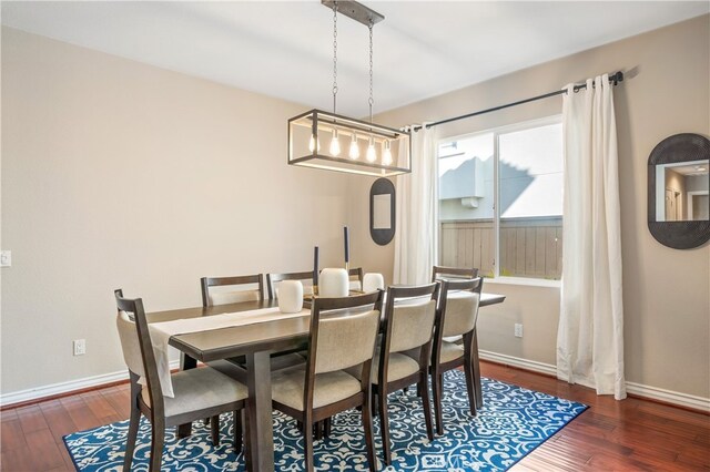 dining area featuring dark wood-type flooring