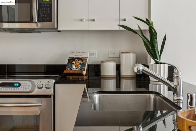 kitchen with white cabinetry, appliances with stainless steel finishes, and sink