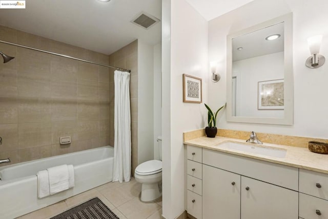 full bathroom with tile patterned flooring, vanity, shower / bath combo, and toilet