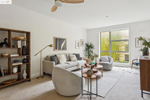 carpeted living room with ceiling fan