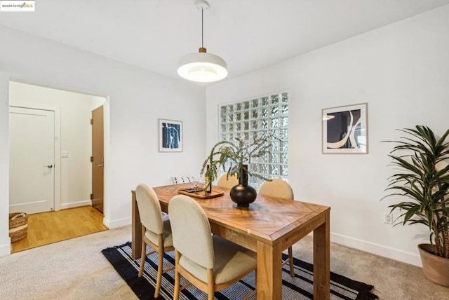 dining area with light colored carpet