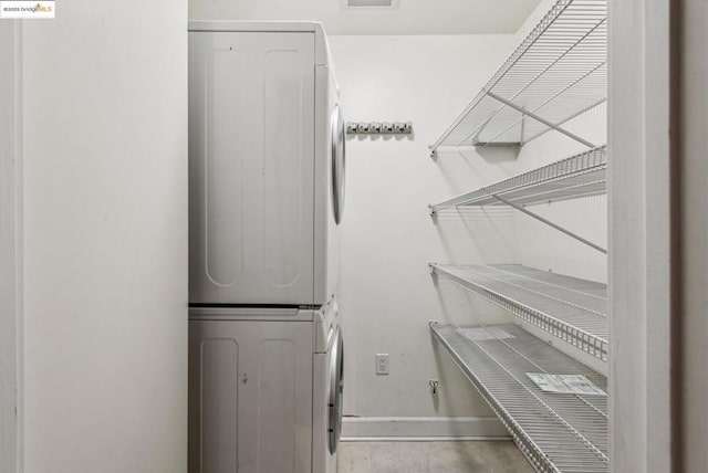 laundry room with stacked washer / drying machine