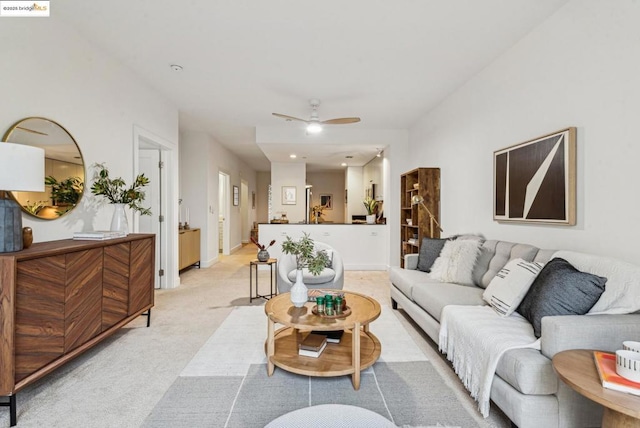 carpeted living room with ceiling fan