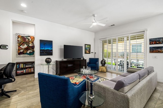 living room featuring ceiling fan and light hardwood / wood-style floors