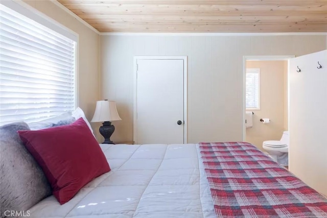 bedroom with connected bathroom and wood ceiling