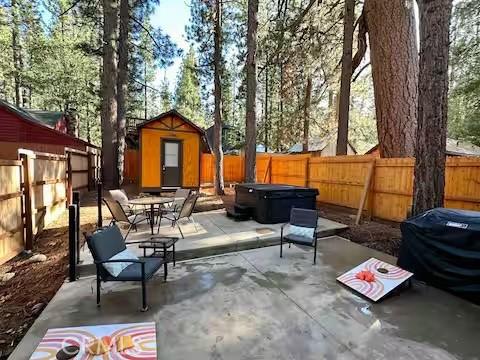 view of patio featuring a storage unit and a hot tub