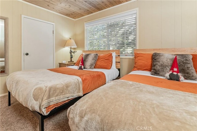 bedroom with wood ceiling, carpet flooring, and crown molding