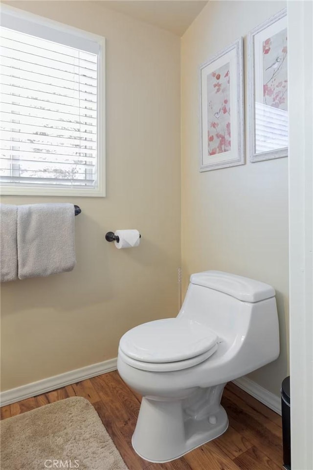 bathroom featuring hardwood / wood-style floors and toilet