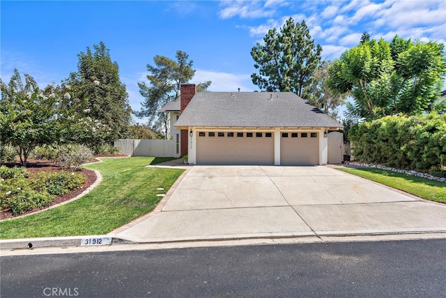 view of front facade with a garage and a front lawn