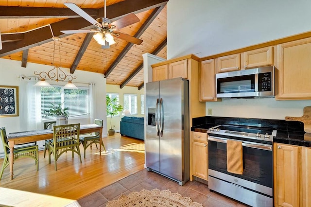 kitchen with pendant lighting, light brown cabinets, and appliances with stainless steel finishes