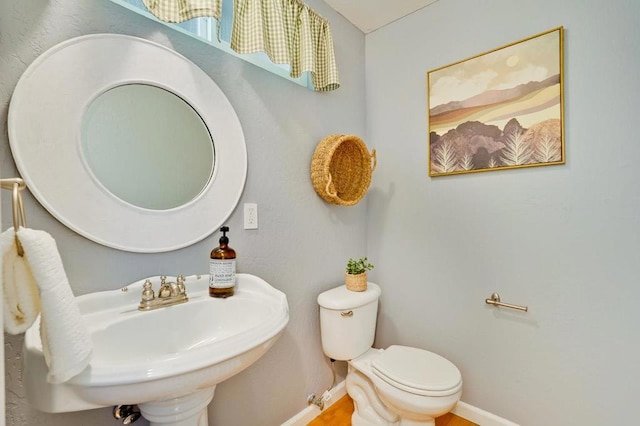 bathroom featuring toilet and sink