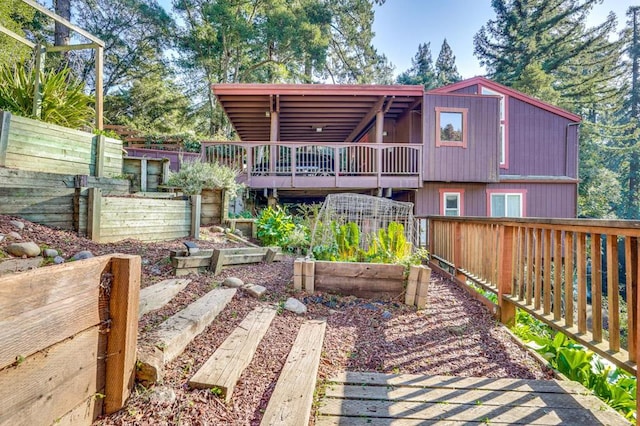 back of property featuring a wooden deck