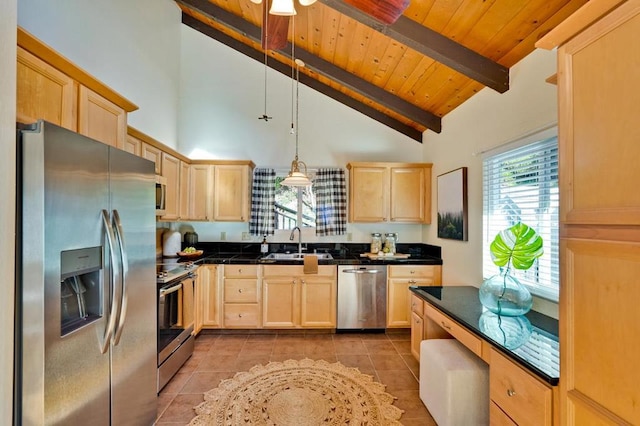 kitchen featuring sink, appliances with stainless steel finishes, beam ceiling, light brown cabinetry, and decorative light fixtures