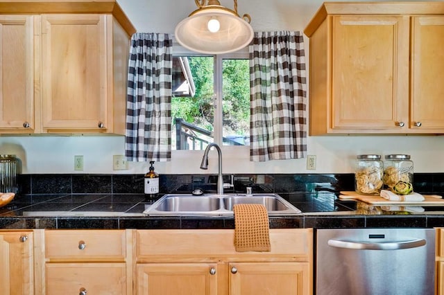 kitchen featuring pendant lighting, sink, stainless steel dishwasher, and light brown cabinetry