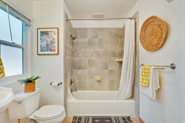 full bathroom with shower / tub combo with curtain, toilet, and sink