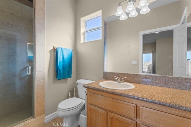 bathroom with an enclosed shower, vanity, and toilet