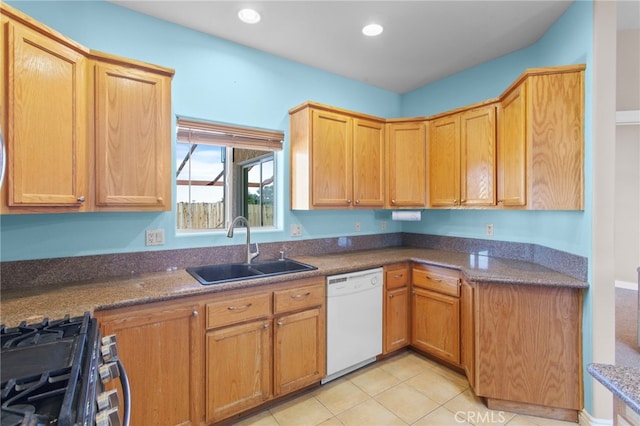 kitchen featuring white dishwasher, sink, stainless steel gas range, and light tile patterned flooring