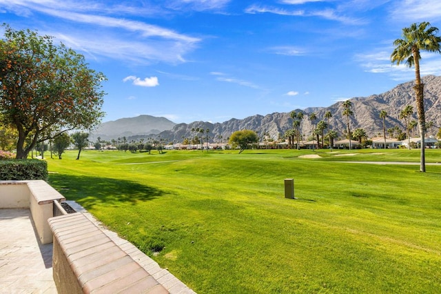 view of home's community featuring a mountain view and a lawn