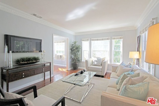 living room featuring cooling unit, ornamental molding, and light hardwood / wood-style flooring