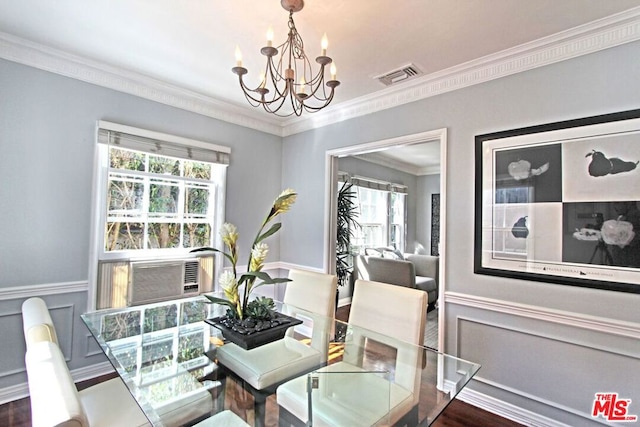 dining space with cooling unit, a notable chandelier, and crown molding