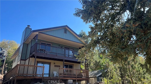 rear view of property with a balcony