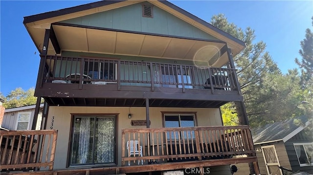 rear view of property with covered porch