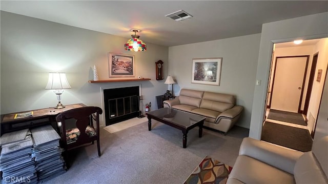 living room featuring carpet, a fireplace with flush hearth, and visible vents