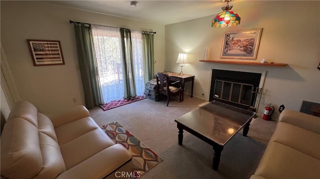 carpeted living room with a glass covered fireplace