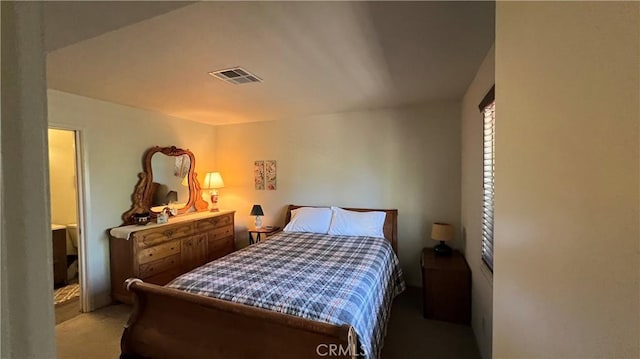 bedroom featuring light colored carpet and visible vents