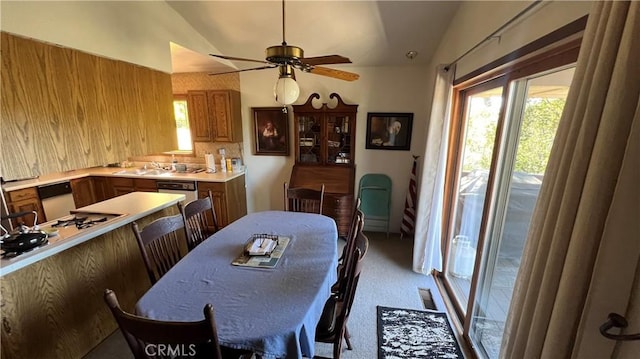 dining room featuring a ceiling fan, visible vents, vaulted ceiling, and carpet floors