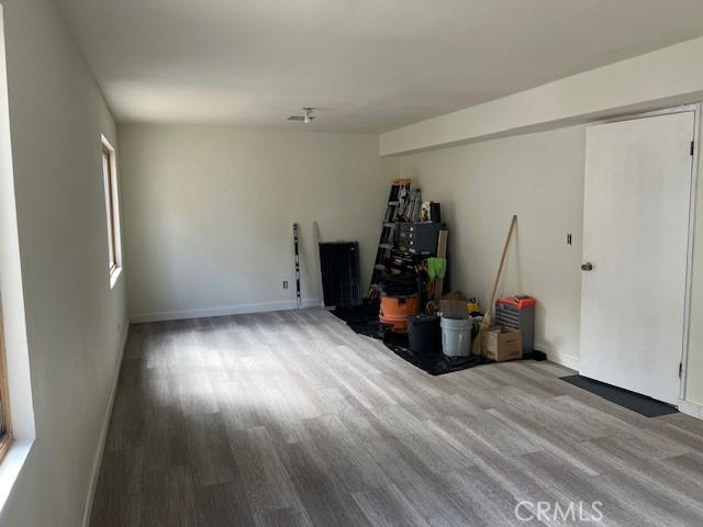 interior space featuring wood finished floors and baseboards