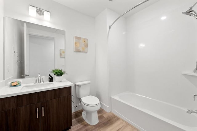 full bathroom featuring vanity, hardwood / wood-style floors, bathing tub / shower combination, and toilet