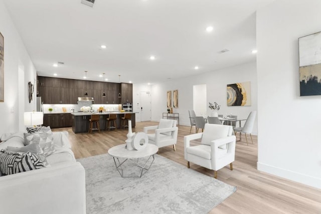 living room with light hardwood / wood-style flooring