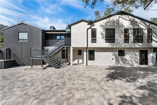 back of house with a patio area and stairs