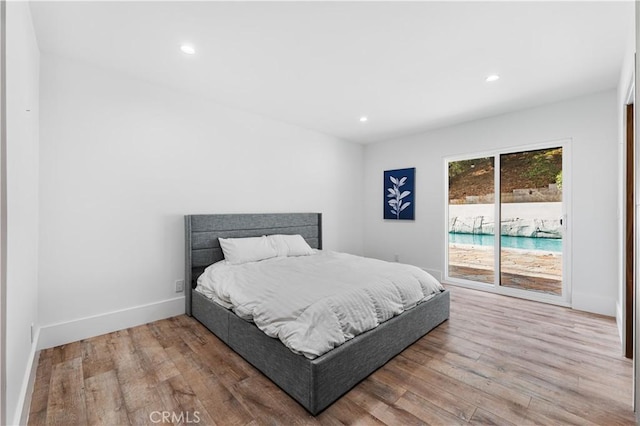 bedroom with baseboards, access to outside, wood finished floors, and recessed lighting