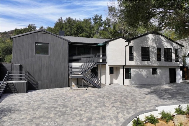 exterior space with a patio, stairway, and a chimney