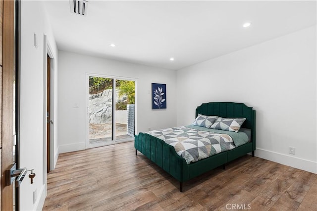 bedroom featuring access to outside, visible vents, wood finished floors, and recessed lighting