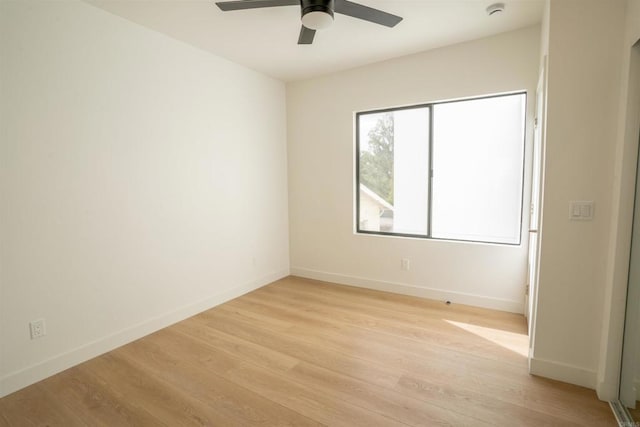 spare room featuring ceiling fan and light hardwood / wood-style flooring