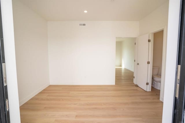 unfurnished room with light wood-type flooring