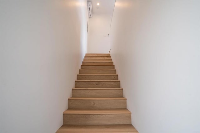 stairs featuring wood-type flooring