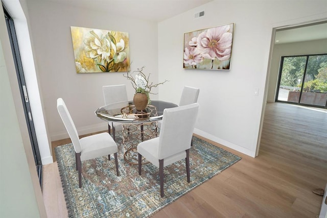 dining space featuring hardwood / wood-style floors