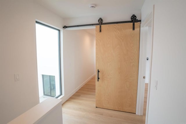 hallway with light hardwood / wood-style floors