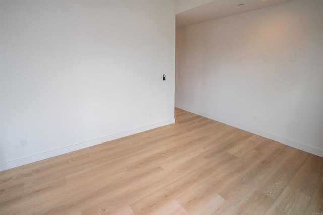 unfurnished room with light hardwood / wood-style flooring