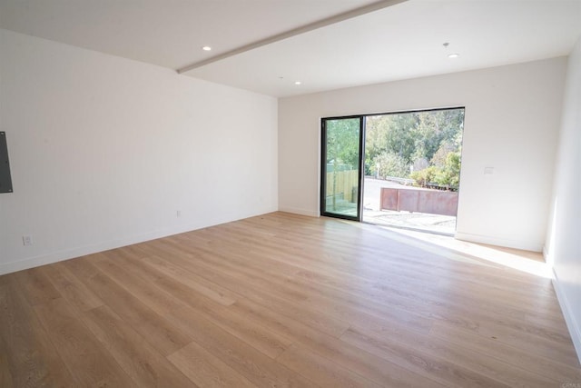 spare room with light hardwood / wood-style flooring