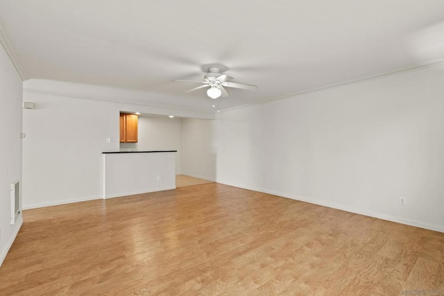 unfurnished room with crown molding, light hardwood / wood-style floors, and ceiling fan