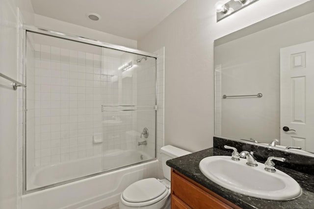 full bathroom with vanity, toilet, and combined bath / shower with glass door