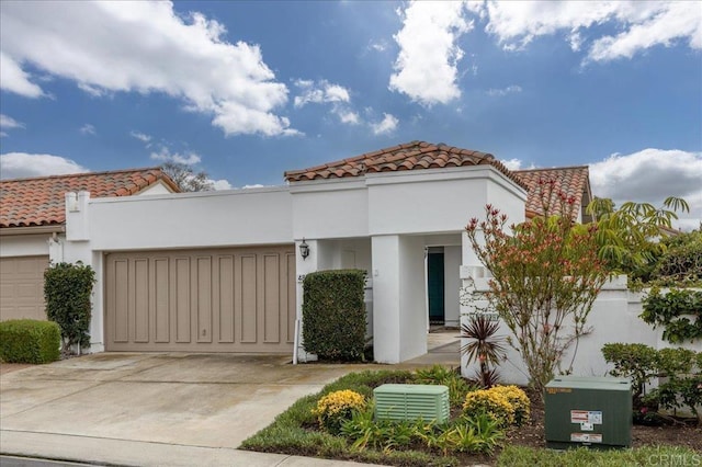 mediterranean / spanish-style home with a garage